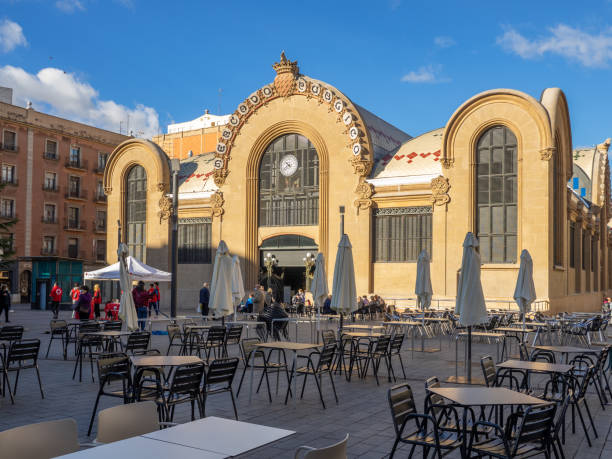 Reus, Tarragona, Spain. December 11, 2021. Reus market square in Tarragona, Spain, with the tables of a bar terrace.