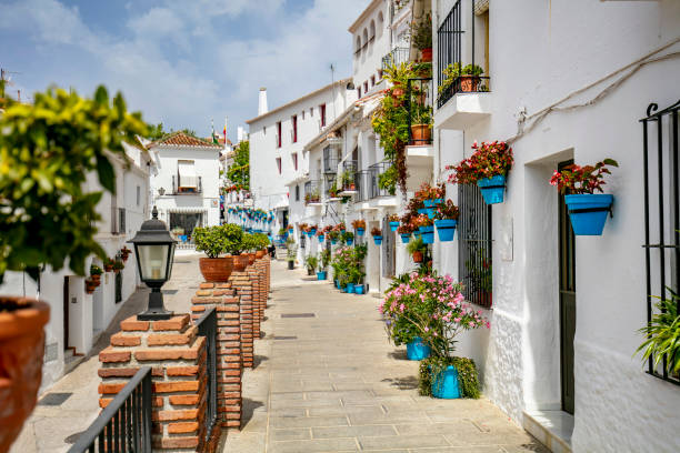 Colorful streets of Mijas, nice strret in Mijas with colorful flower pots in the walls.